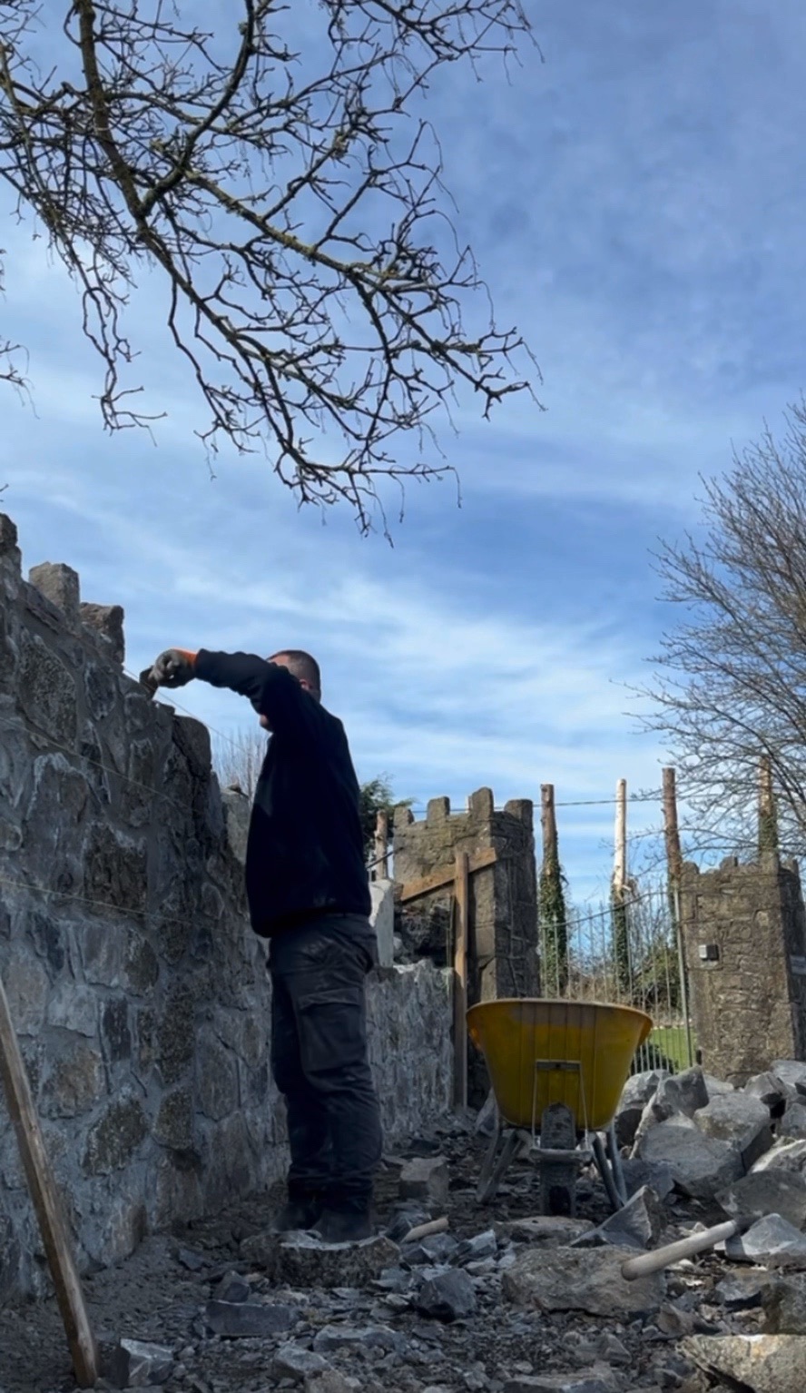 Bledar Cankaj building a stone wall course by course